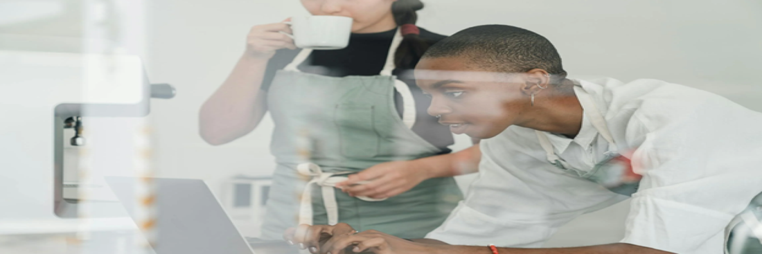 Source: Pexels {Alt text: Two women in aprons working on a laptop together.}